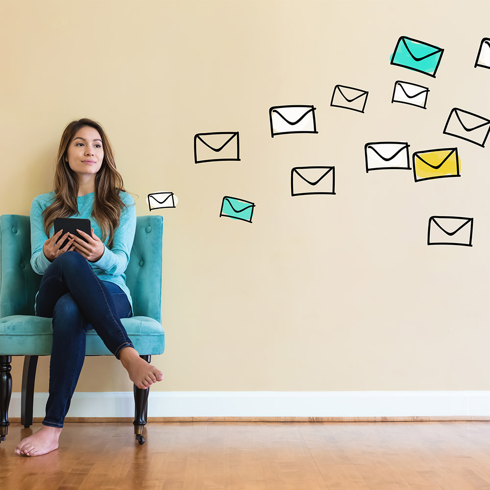 photo of a woman checking email on a couch